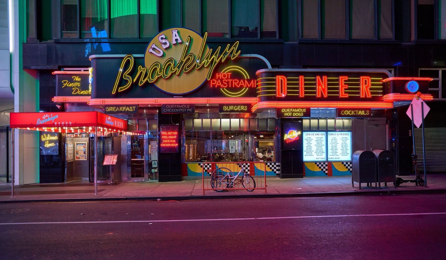 A neon-lit diner front on a Manhattan street at night