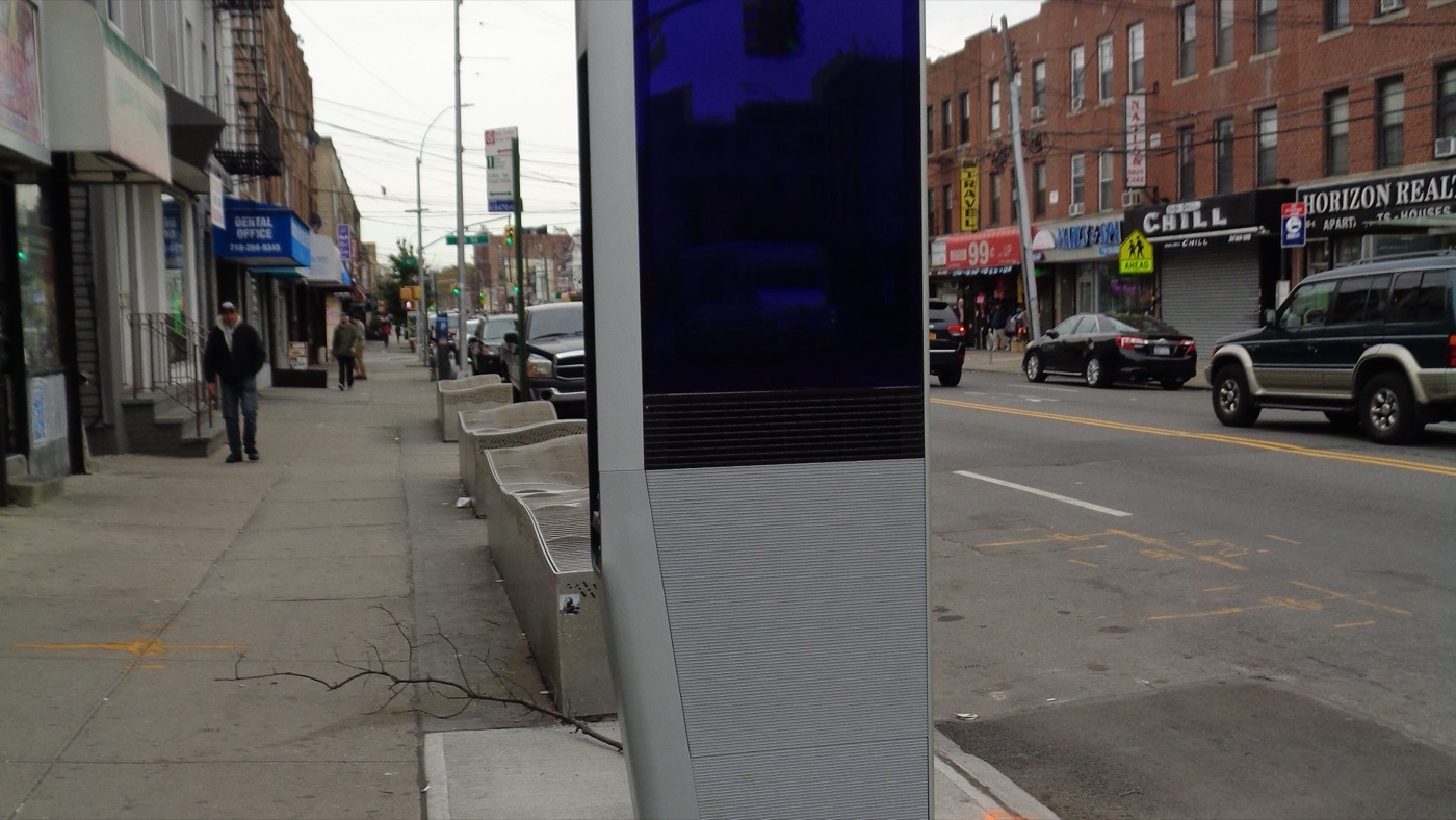 A LinkNYC kiosk on a Queens sidewalk