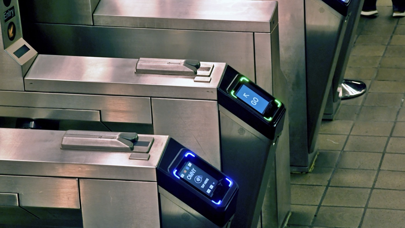 A contactless fare reader at a subway turnstile